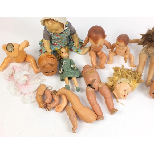 710 - Eight vintage composite dolls, some with jointed limbs and open/close eyes, the largest 60cm high