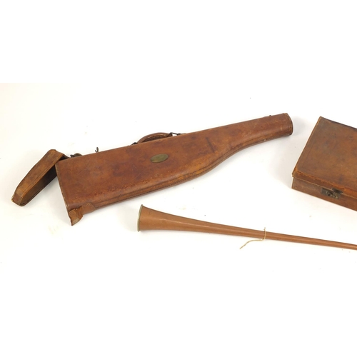 1119 - Two leather gun cases and a copper hunting horn by Keats of London, the largest 102cm in length