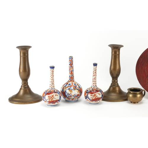 651 - Miscellaneous items including a pair of coppered candlesticks, three Imari vases and a lacquered tra... 