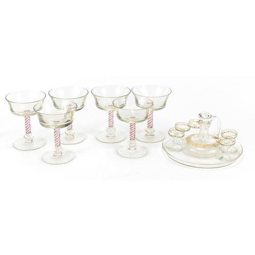 653 - Glassware including a cabaret service, gilded with flowers and six glasses with air twist stems, the... 