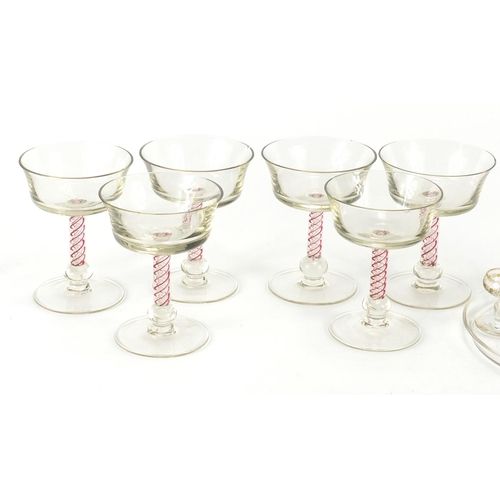 653 - Glassware including a cabaret service, gilded with flowers and six glasses with air twist stems, the... 