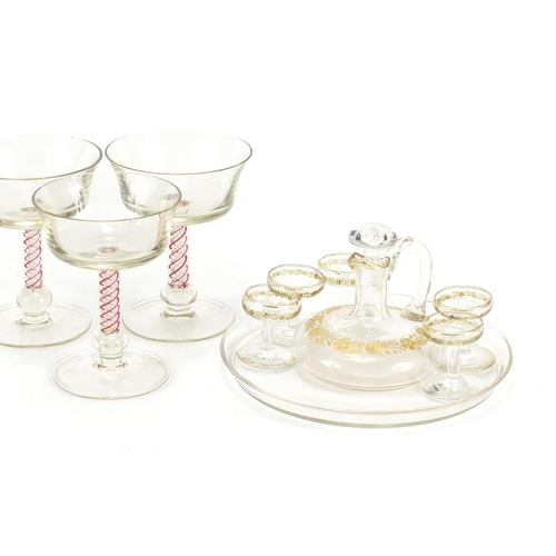 653 - Glassware including a cabaret service, gilded with flowers and six glasses with air twist stems, the... 