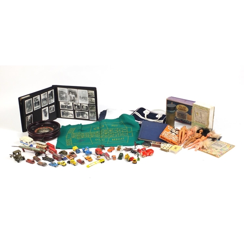 680 - Vintage and later toys, stamps and postcards including die cast vehicles, 1960's dolls and a roulett... 