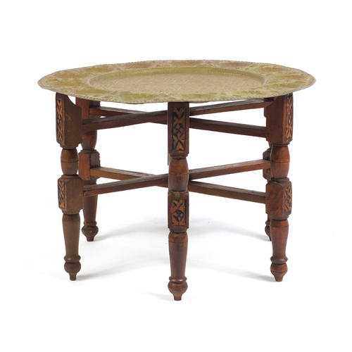 69 - Indian brass tray topped folding table, 46cm high x 56cm in diameter