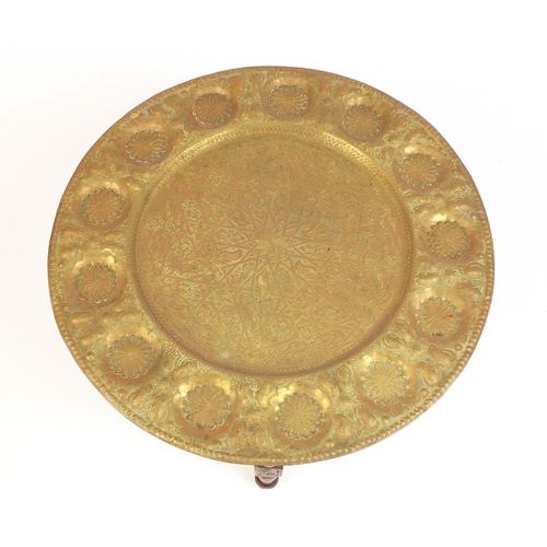 69 - Indian brass tray topped folding table, 46cm high x 56cm in diameter