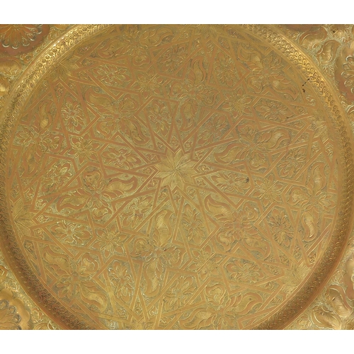 69 - Indian brass tray topped folding table, 46cm high x 56cm in diameter