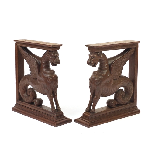 68 - Pair of carved oak griffin brackets, 38cm high