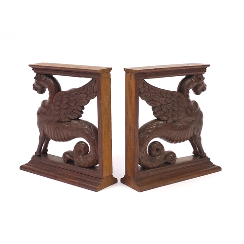 68 - Pair of carved oak griffin brackets, 38cm high