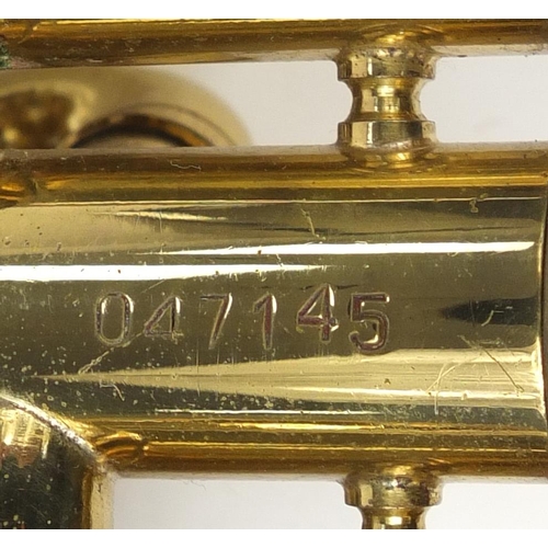 599 - Brass Corton coronet, with fitted case, 50cm in length