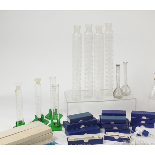 648 - Large selection of chemist measures and  syringes, test tubes and beakers