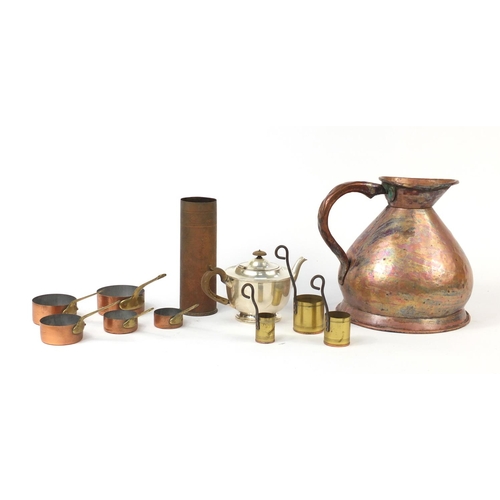 623 - Metalwares including a large copper flagon, graduated set of pans and a trench art shell case