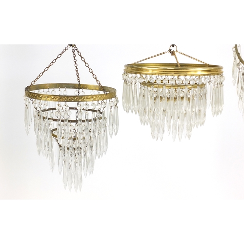 701 - Three circular brass chandeliers with cut glass drops, the largest 40cm high x 25cm in diameter