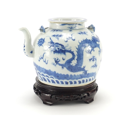 2309 - Chinese blue and white porcelain teapot raised on carved hardwood stand, the teapot hand painted wit... 