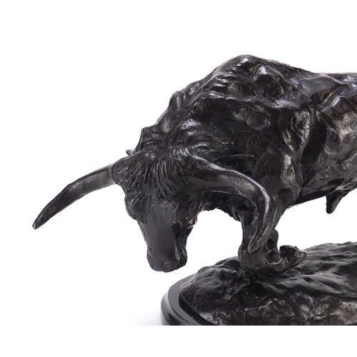 2302 - Patinated bronze model of a bull raised on a shaped black marble base, 35cm wide