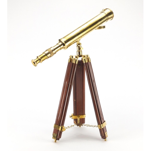 2038 - Brass table top telescope raised on stained wood tripod stand