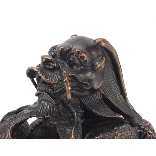 2199 - Oversized Chinese patinated bronze dragon seal, character marks to the base, 16cm high