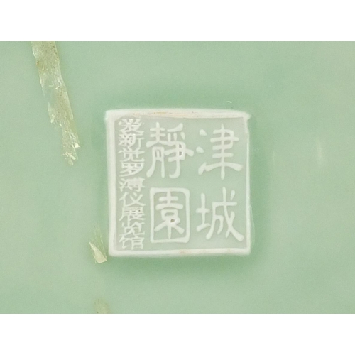 2227 - Chinese celadon glazed plate decorated with a waterfall outside a building, character marks to the r... 