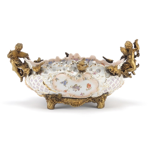 2319 - Continental porcelain centre piece with gilt metal mounts decorated with flowers, 40cm wide