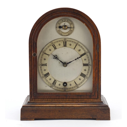 2316 - Oak cased mantel clock with silvered dial and chapter rings, having Roman and Arabic numerals, the m... 