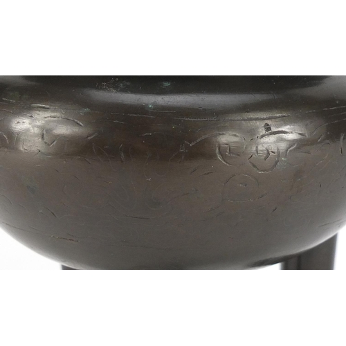 2214 - Chinese archaic style bronze tripod censer with twin handles, engraved with foliate motifs, 15cm hig... 