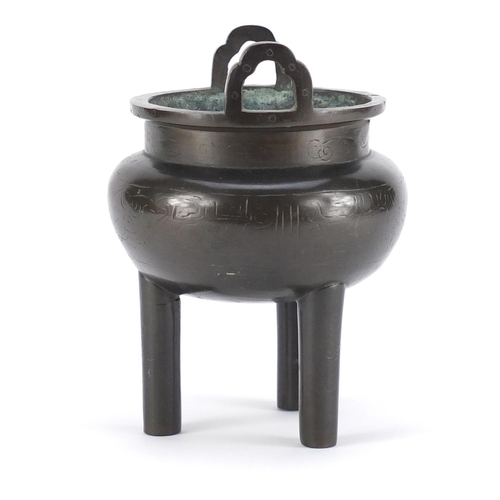 2214 - Chinese archaic style bronze tripod censer with twin handles, engraved with foliate motifs, 15cm hig... 