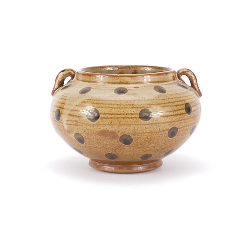 319 - Chinese porcelain squatted vase with twin handles having a brown glaze, 10cm high