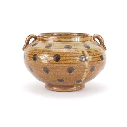 319 - Chinese porcelain squatted vase with twin handles having a brown glaze, 10cm high