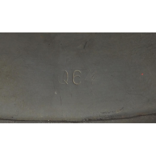 2463 - German Military interest tin helmet with decals and leather liner, impressed marks to the interior