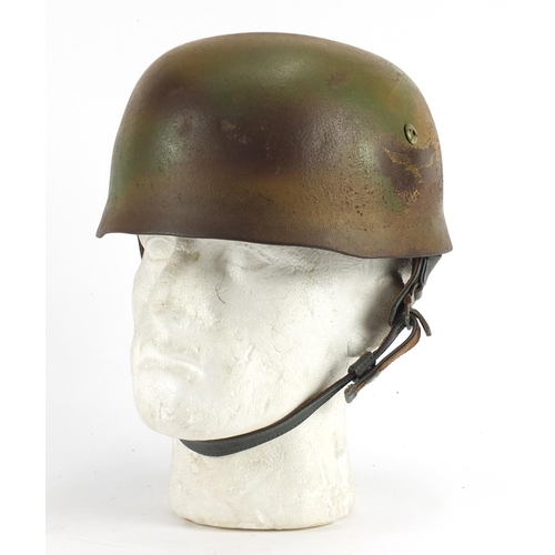 2462 - German Military interest tin helmet with decal and leather liner, stamped marks to the interior