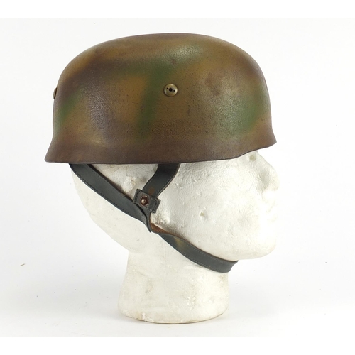 2462 - German Military interest tin helmet with decal and leather liner, stamped marks to the interior