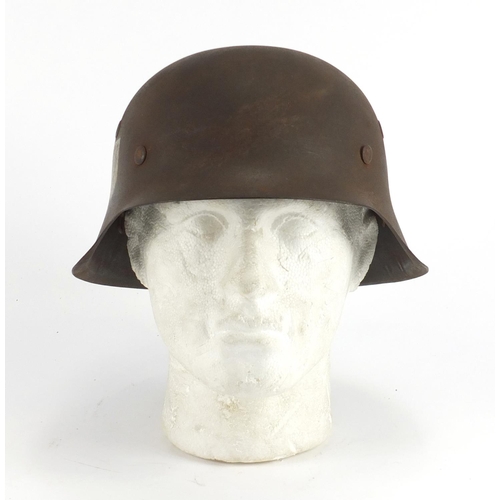 2469 - German Military interest tin helmet with decals, impressed marks to the interior