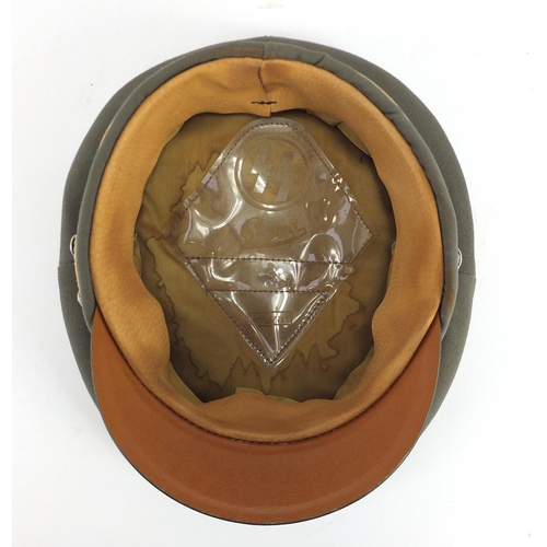 2471 - German Military interest visor cap with badges