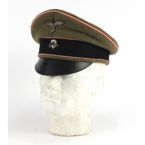 2473 - German Military interest visor cap with badges