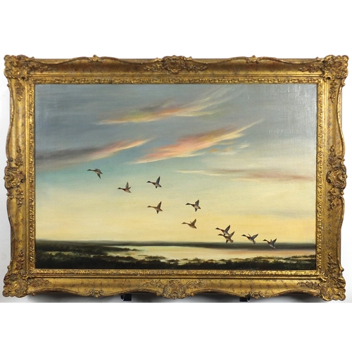 2085 - Wilfred Bailey - Ducks in flight over water, oil on canvas, framed, 76cm x 50cm