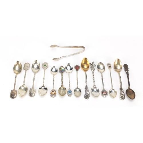 2516 - Mostly silver souvenir teaspoons, a set of three silver rifle club teaspoons and a pair of sugar ton... 
