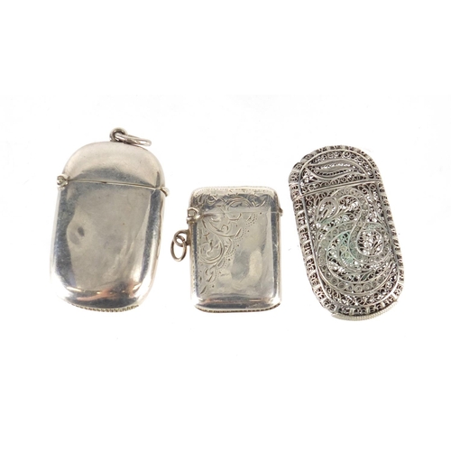 2509 - Two silver vesta's and a filigree metal vesta, the largest 5.5cm in length, 54.2g