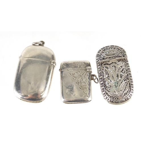 2509 - Two silver vesta's and a filigree metal vesta, the largest 5.5cm in length, 54.2g