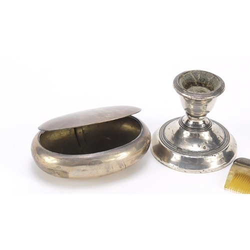 2515 - Silver objects comprising a squeeze action snuff box, dwarf candlestick and a comb, various hallmark... 