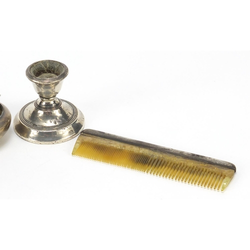 2515 - Silver objects comprising a squeeze action snuff box, dwarf candlestick and a comb, various hallmark... 