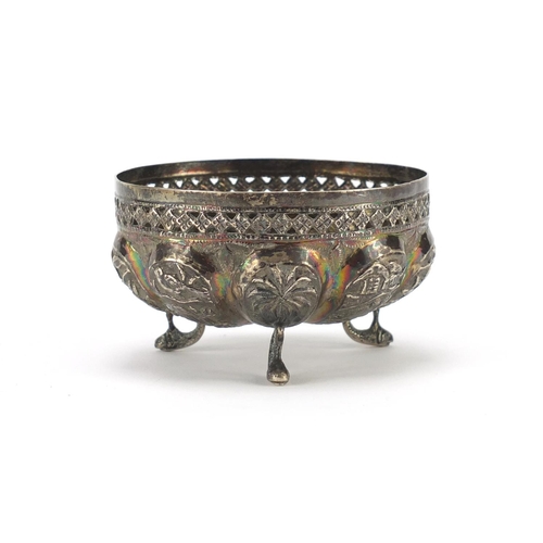 2533 - Indian unmarked silver bowl embossed with wild animals and raised on three dolphin feet, 9cm in diam... 