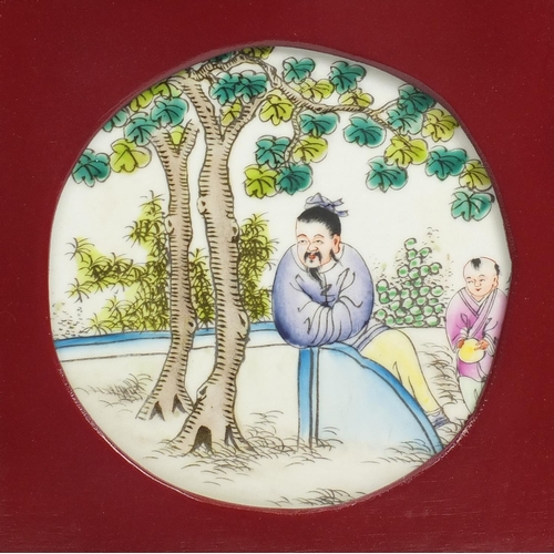2077 - Three Chinese porcelain panels hand painted in the famille rose palette with figures, housed in carv... 