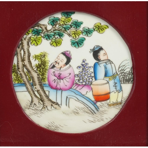 2078 - Three Chinese porcelain panels hand painted in the famille rose palette with figures, housed in carv... 