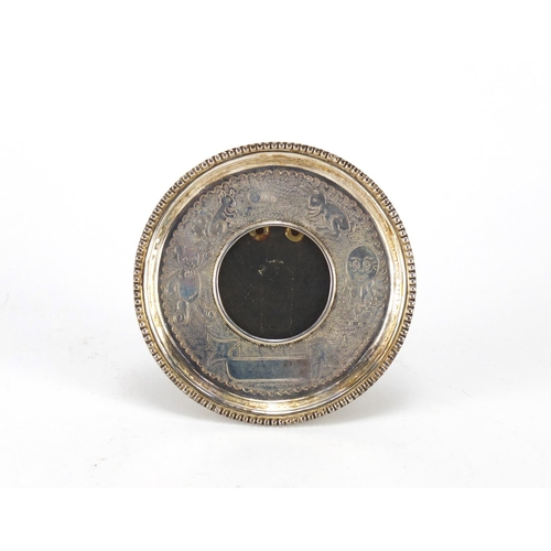 2508 - Circular sterling silver nursery rhyme easel photo frame, 10.5cm in diameter