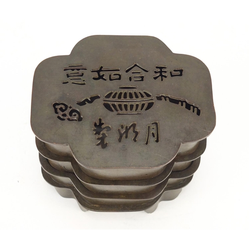 2111 - Chinese patinated bronze three section container, character marks to the base, 9.5cm high