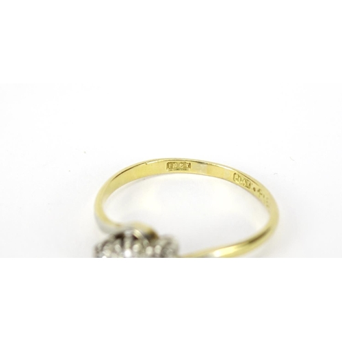 2573 - 18ct gold diamond three stone crossover ring, size N, 2.1g
