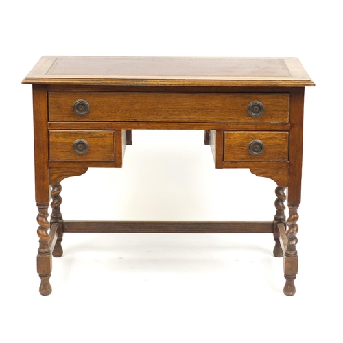 13 - Oak writing desk with tooled red leather insert and three drawers, raised on barley twist legs, 73cm... 