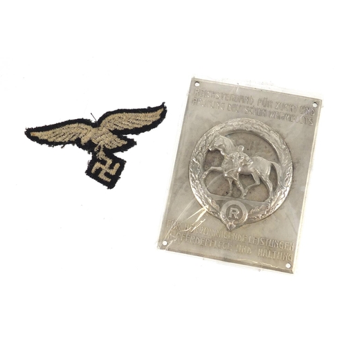 245 - German Military interest cloth patch and silvered metal plaque, the plaque 7.5cm x 6cm