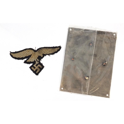 245 - German Military interest cloth patch and silvered metal plaque, the plaque 7.5cm x 6cm