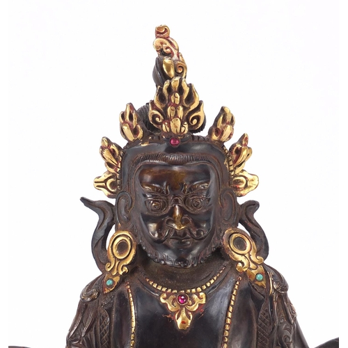 385 - Chino Tibetan partially gilt bronze figure of Buddha with a rat, 31cm high