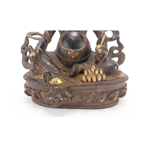 385 - Chino Tibetan partially gilt bronze figure of Buddha with a rat, 31cm high